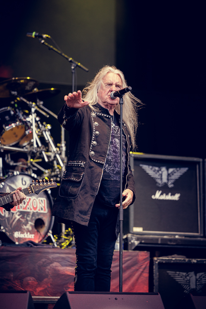 <a href='/artists/saxon/'>Saxon</a>