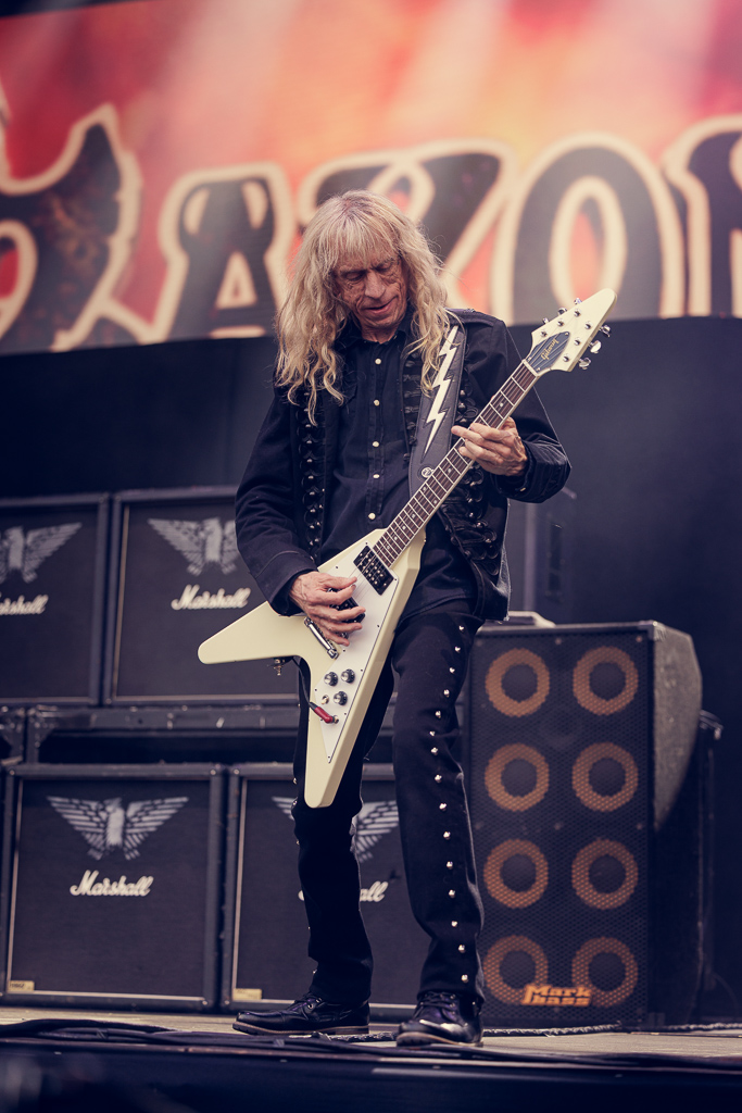 <a href='/artists/saxon/'>Saxon</a>